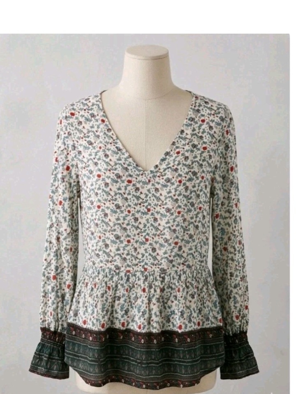 Suzanne Betro Ivory Floral V-Neck Peplum Top with Green Hem and Red Blooms